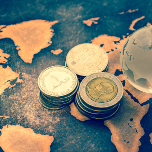 Coins and a globe symbolizing international tax planning for expatriates.