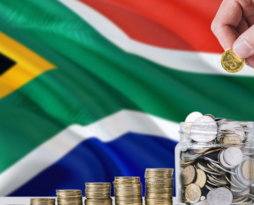 South African flag with coins being added to a jar, symbolizing expat tax changes.