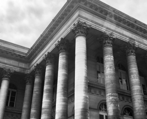 "Historic building with pillars, representing the South African Treasury, central to financial emigration discussions.