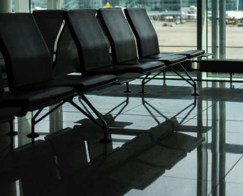 Empty airport seats representing halted international travel during COVID-19 lockdowns