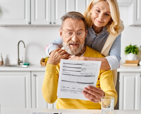 Couple reviewing financial documents, reflecting concerns about retirement funds and exit tax implications for South Africans abroad.