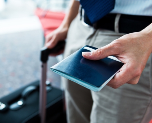“South African expatriate holding a passport ready for international travel, symbolizing tax residency and expatriate tax matters.