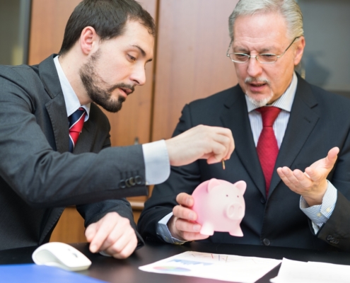 Two professionals discussing financial planning for foreign retirement funds, focusing on SARS regulations for South African expatriates.