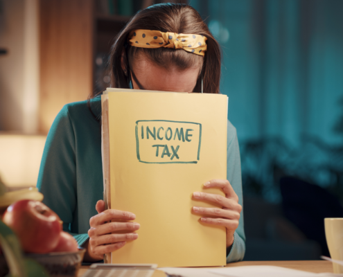 Worried woman reviewing documents about expat tax treaties and compliance.