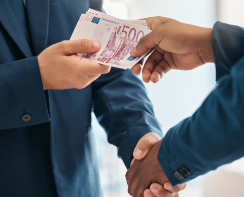 Businessmen exchanging euro notes, illustrating SARB income transfer rules and cross-border money regulations.
